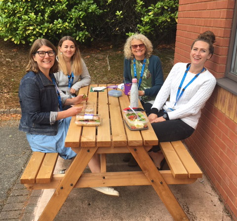 Four ladies enjoying a Bench tables at Talkworks