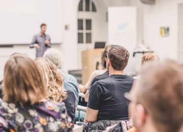Corporate meeting with someone conducting a presentation