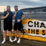 Andrew and Paul being photographed with the medals after completing the event.