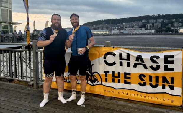 Andrew and Paul being photographed with the medals after completing the event.