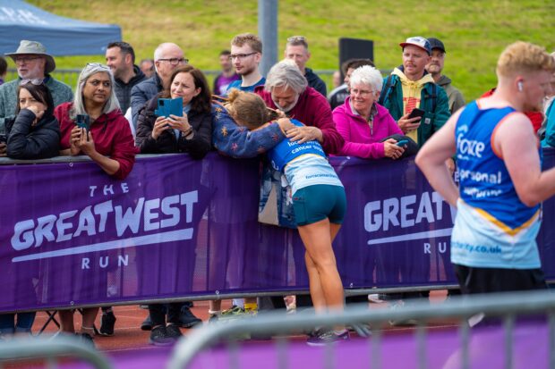 Runner hugging a friend at the event.