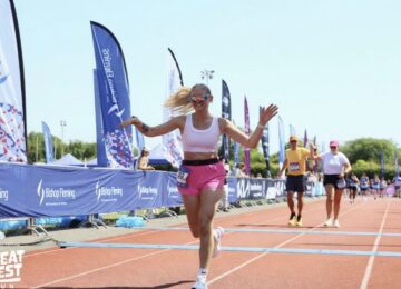 Rhiannon crossing the finish line at the Great West Run.