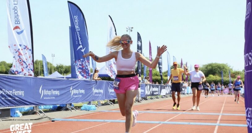 Rhiannon crossing the finish line at the Great West Run.