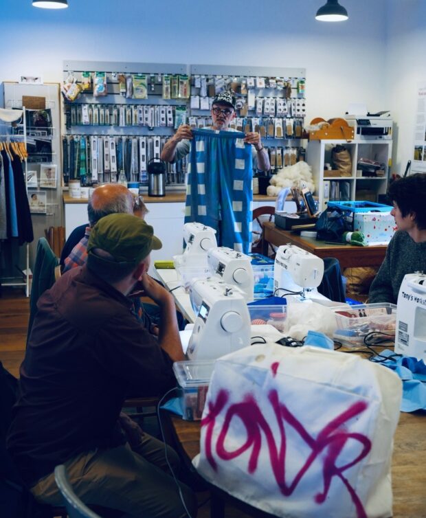 Everyone listening to Tony the instructor at the men's sewing group.