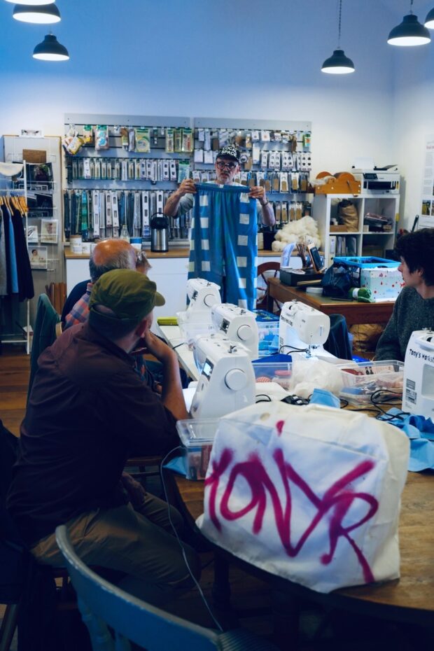 Everyone listening to Tony the instructor at the men's sewing group.