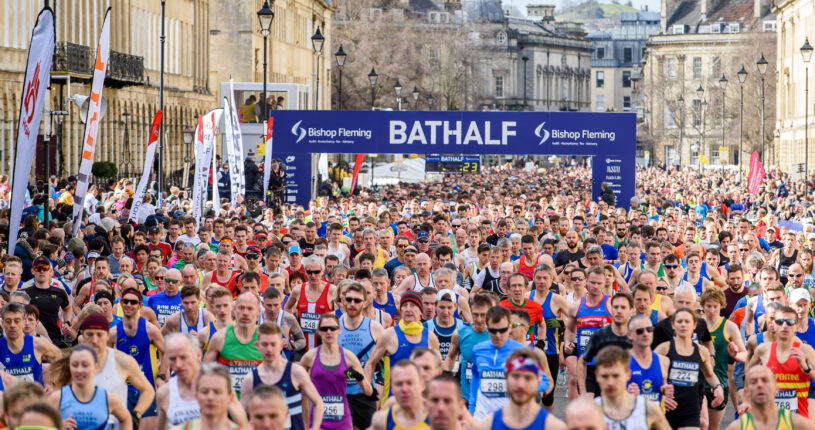 Lots of runners at the Bath Half Marathon running over the start line