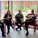 Staff at the event playing instruments and singing.