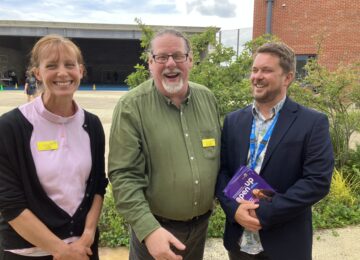 3 people at the event enjoying a conversation together.