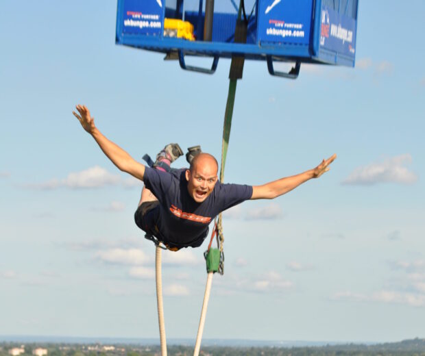 Someone taking a leap of the bungee tower.