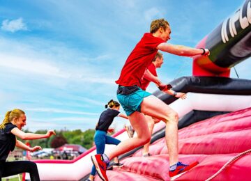 People running up an inflatable at the event.
