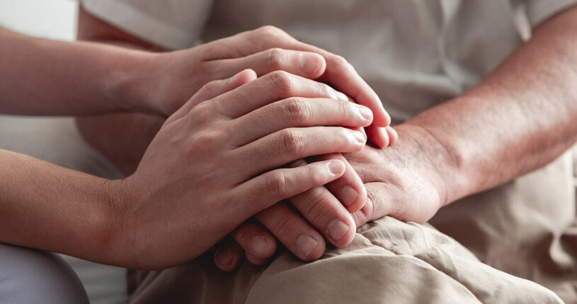 Two pairs of hands on a lap